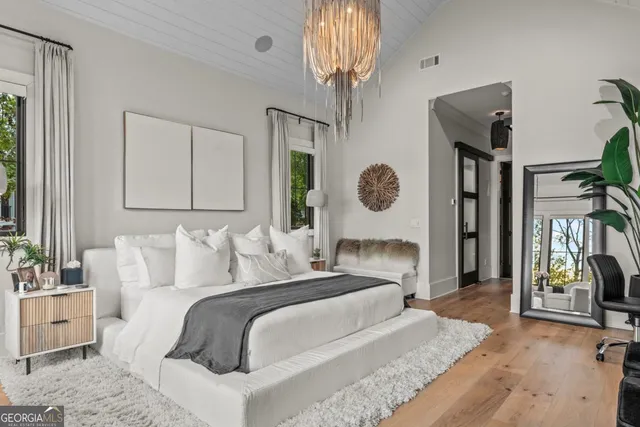 a bedroom with a bed and a couch next to a window