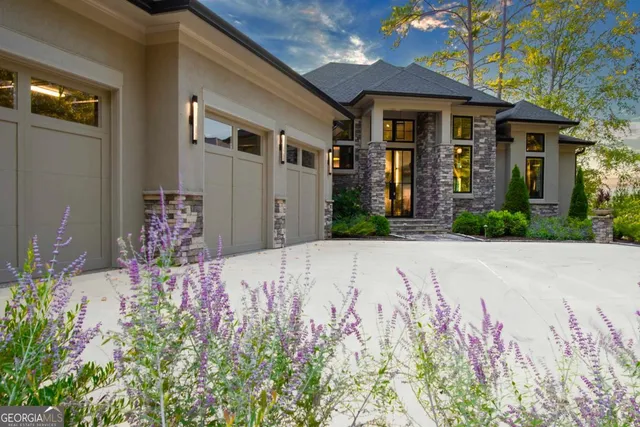 a living room with furniture a flat screen tv and a large window