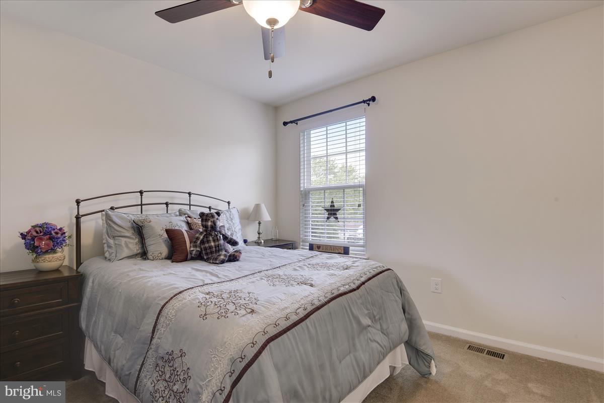 1638 Cape May Road Baltimore, MD 21221 - Photo 22 of 30 a bedroom with a bed and a chandelier