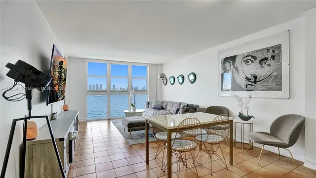 a view of a livingroom with furniture and a flat screen tv