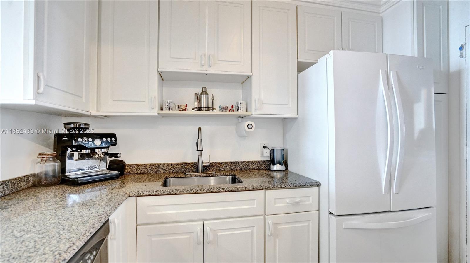 1228 West Avenue, Unit 201 Miami Beach, FL 33139 - Photo 17 of 42 a kitchen with appliances cabinets and a counter top space