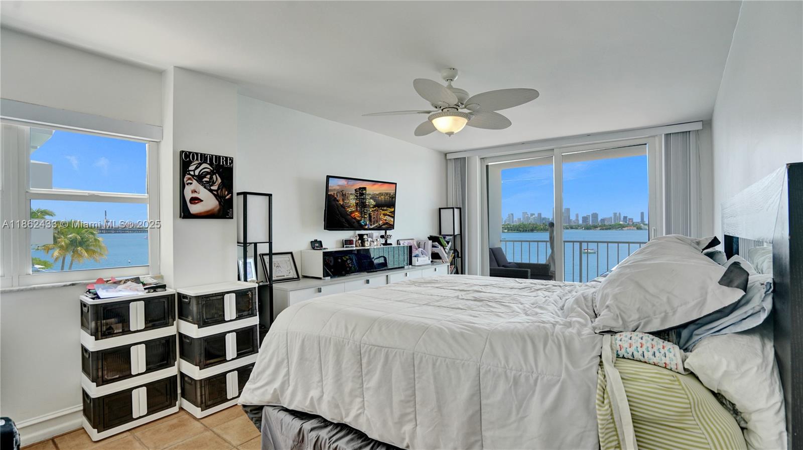 1228 West Avenue, Unit 201 Miami Beach, FL 33139 - Photo 18 of 42 a bed room with a bed window and mirror