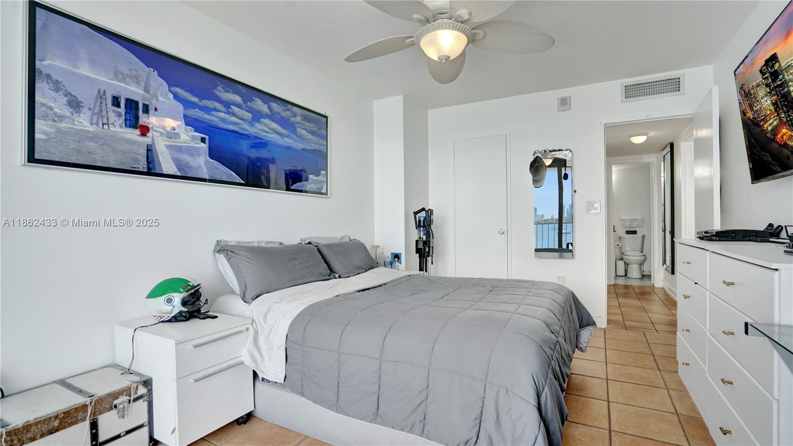 1228 West Avenue, Unit 201 Miami Beach, FL 33139 - Photo 20 of 42 a spacious bedroom with a bed and a cabinets
