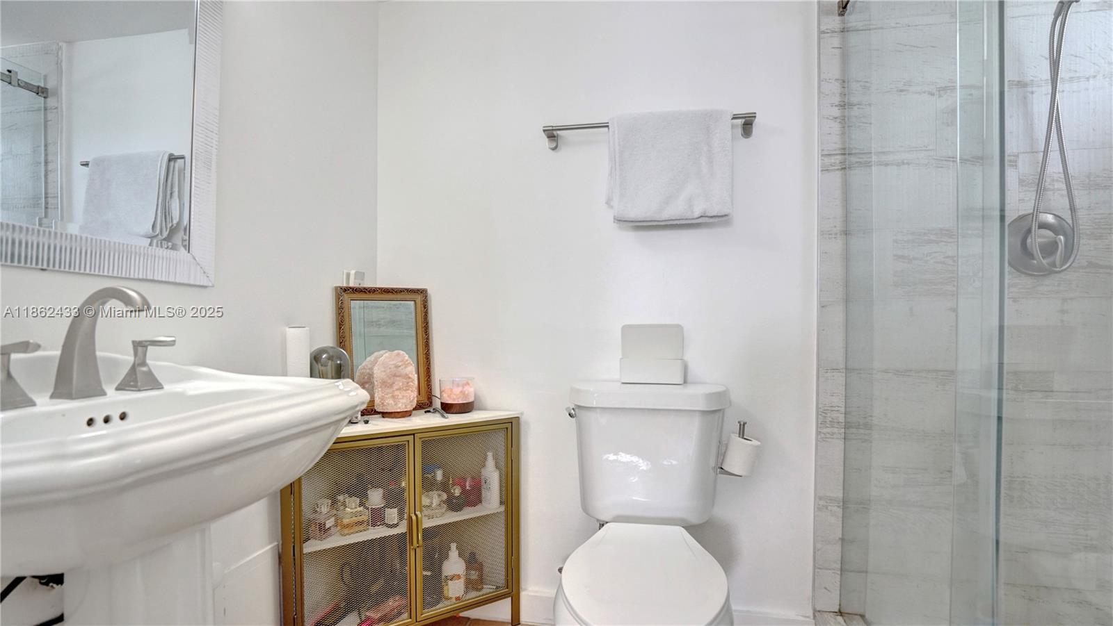 1228 West Avenue, Unit 201 Miami Beach, FL 33139 - Photo 21 of 42 a bathroom with a sink toilet and shower