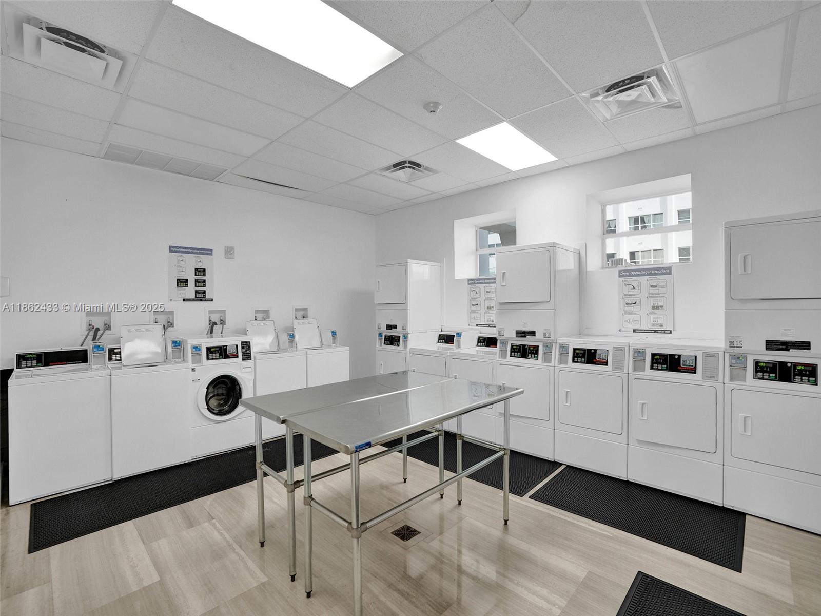 1228 West Avenue, Unit 201 Miami Beach, FL 33139 - Photo 41 of 42 a view of a kitchen with furniture and wooden floor