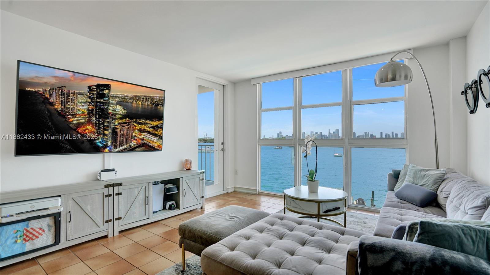 1228 West Avenue, Unit 201 Miami Beach, FL 33139 - Photo 8 of 42 a living room with furniture a rug and a floor to ceiling window