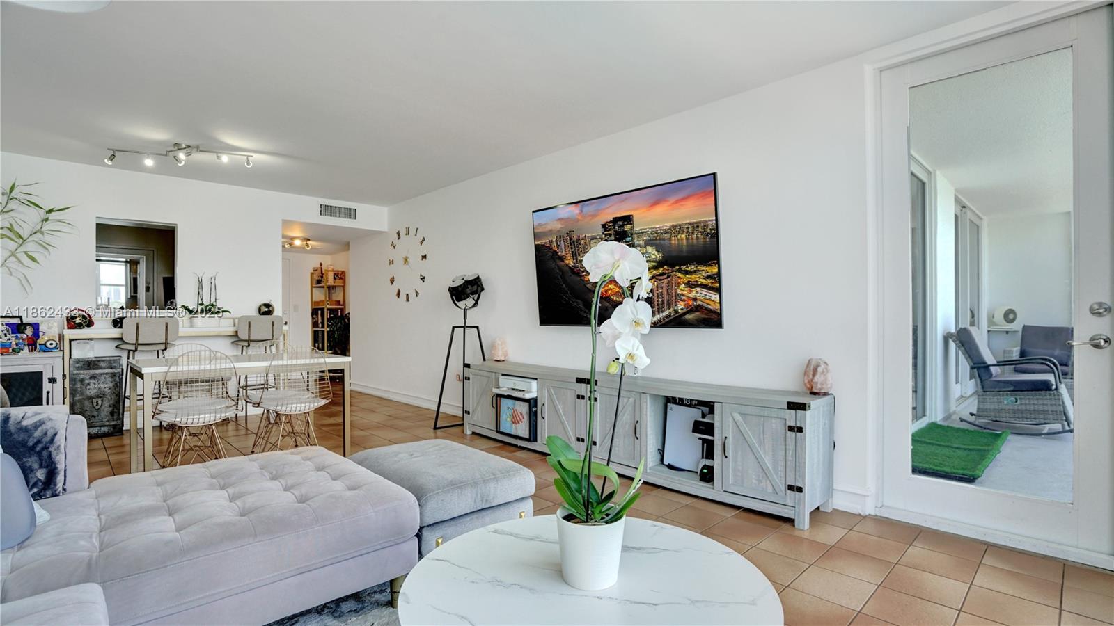1228 West Avenue, Unit 201 Miami Beach, FL 33139 - Photo 9 of 42 a living room with furniture and a chandelier