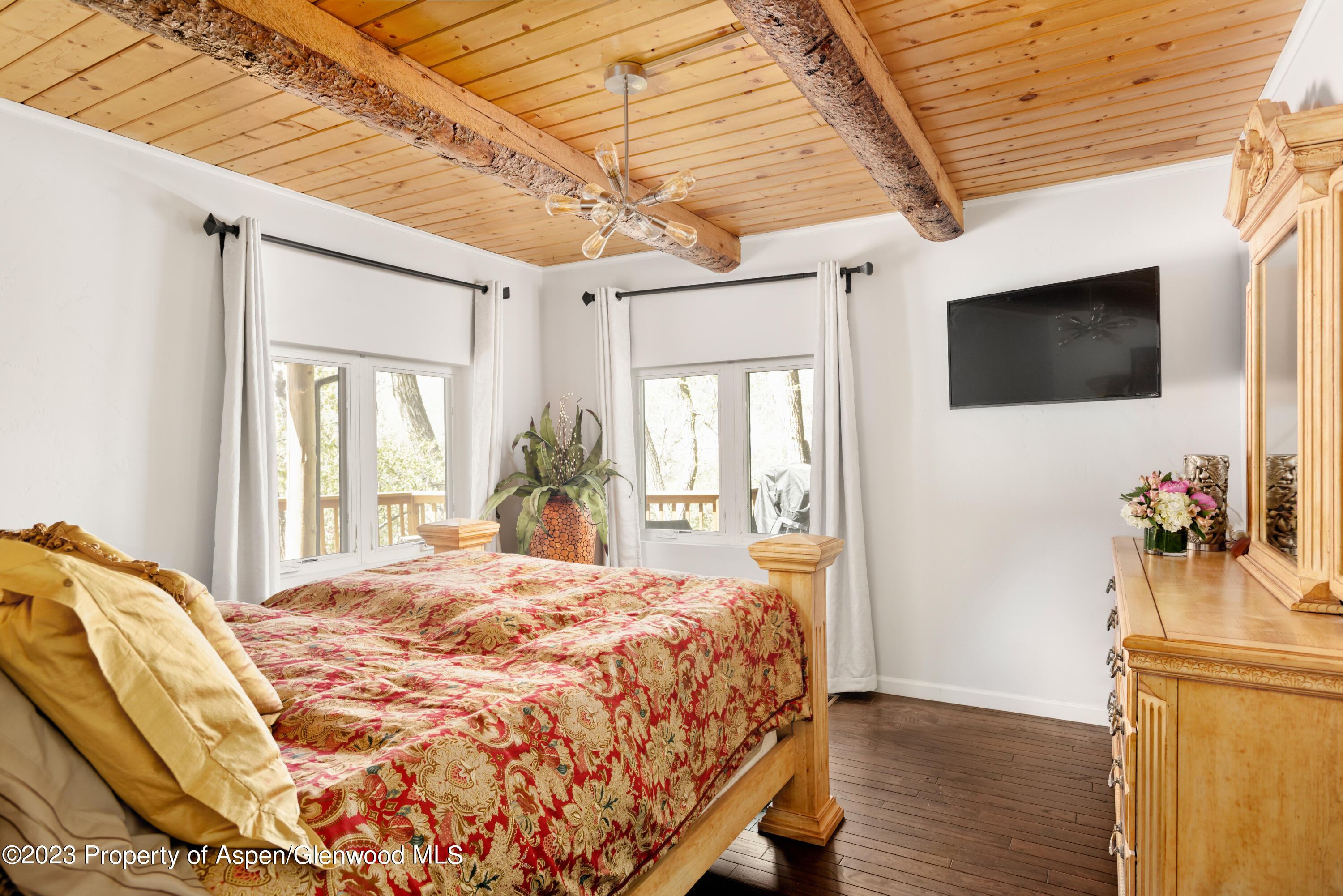 1649 Emma Spur Basalt, CO 81621 - Photo 8 of 35 a bedroom with a bed and a flat screen tv