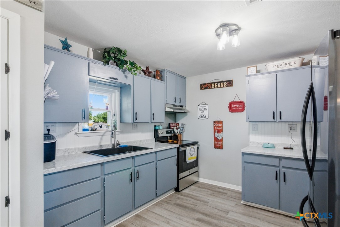 201 Pheasant Drive Victoria, TX 77905 - Photo 11 of 20 a kitchen with a sink cabinets and wooden floor
