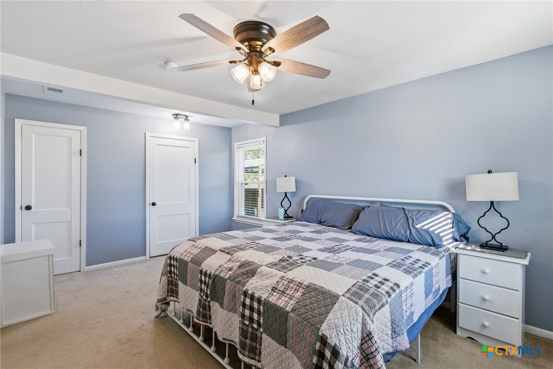 201 Pheasant Drive Victoria, TX 77905 - Photo 15 of 20 a bedroom with a bed and a chandelier