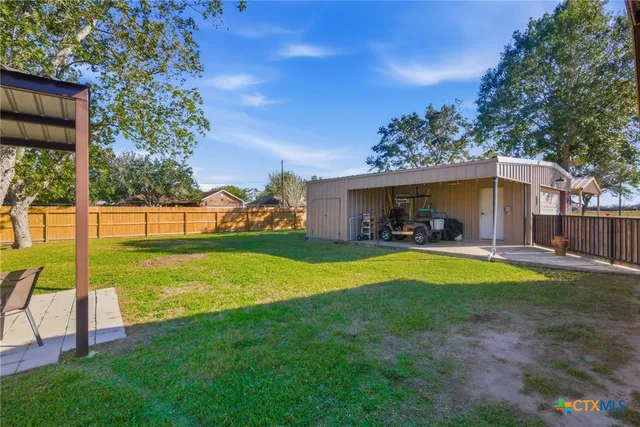 a view of a house with backyard and porch