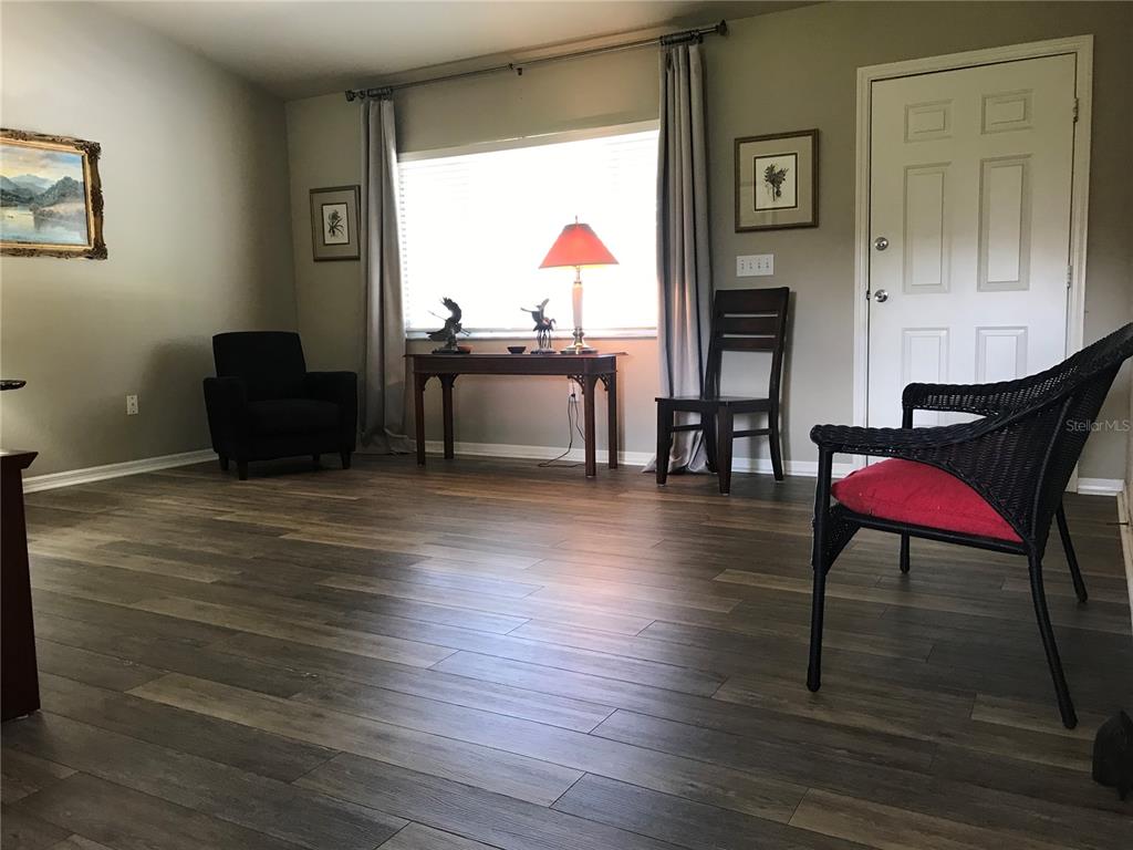 11879 Southwest 137th Loop Dunnellon, FL 34432 - Photo 8 of 37 a living room with furniture a rug and a wooden floor