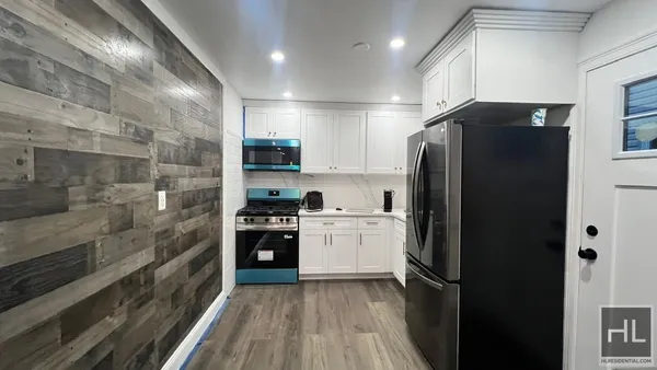 a kitchen with a refrigerator and a stove