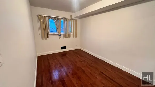 a view of utility room with wooden floor and fan