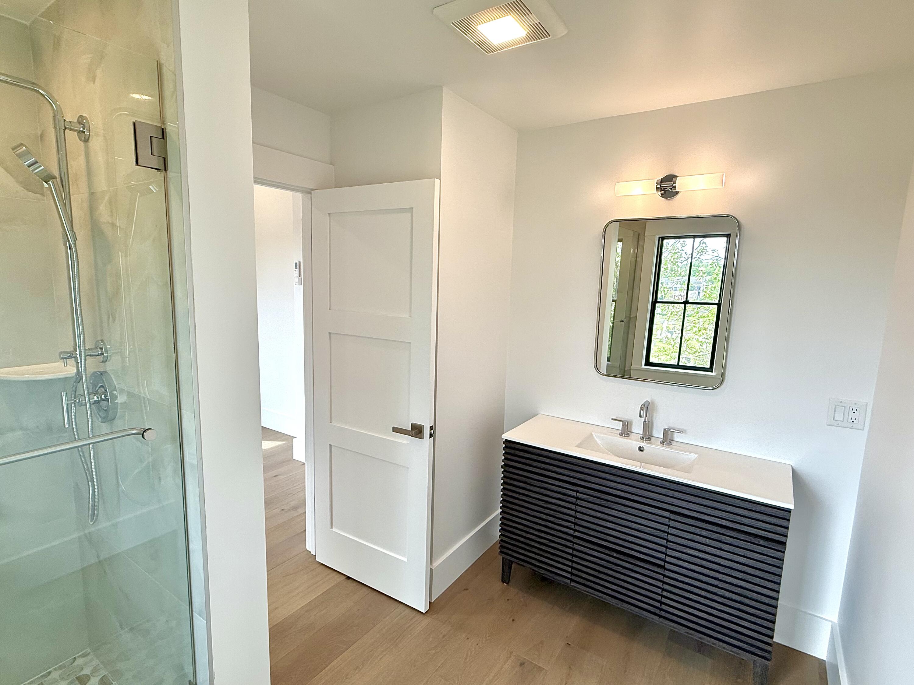 29 Cemetery Road, Unit 2 Provincetown, MA 02657 - Photo 29 of 30 a bathroom with a sink a mirror and a shower