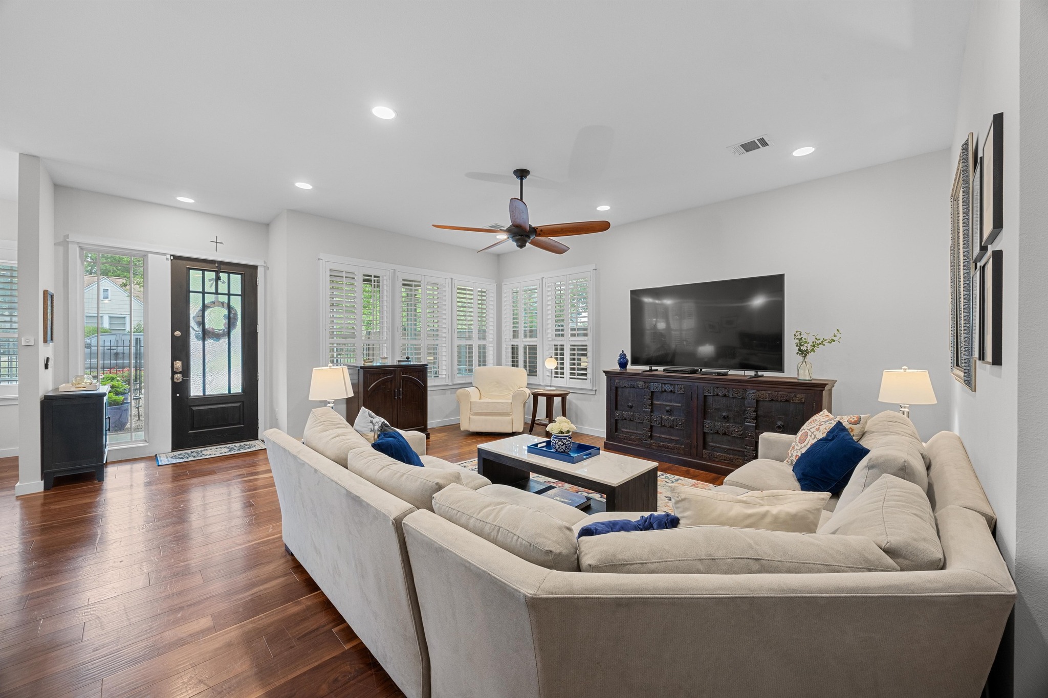 3907 Becker Avenue Austin, TX 78751 - Photo 7 of 37 Living room featuring custom shutters, wood floors, recessed lighting and high ceilings.