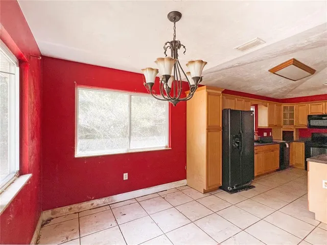 a view of a room with window and chandelier