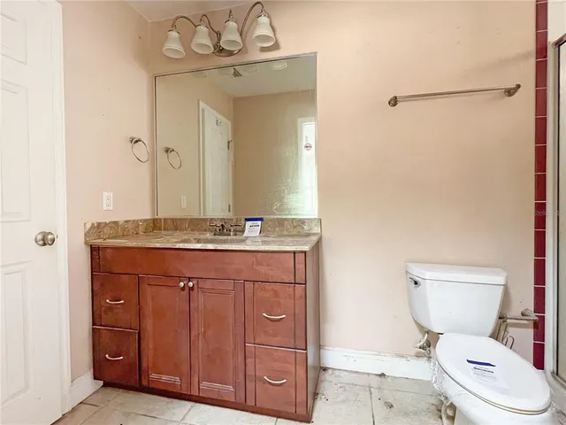 a bathroom with a shower and a toilet