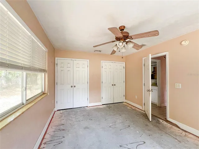 a view of a livingroom with a ceiling fan and window