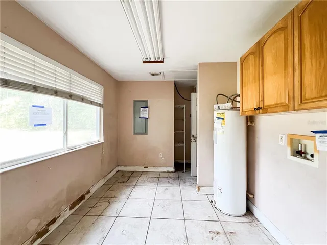 a view of a kitchen with refrigerator and window