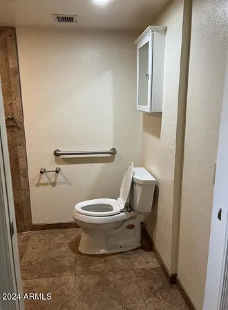 a white toilet sitting next to a bathroom sink
