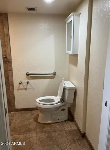 a white toilet sitting next to a bathroom sink