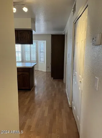 a view of room with window and wooden floor