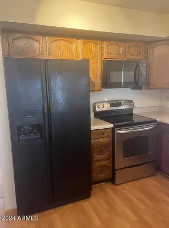 a kitchen with a stove and a refrigerator