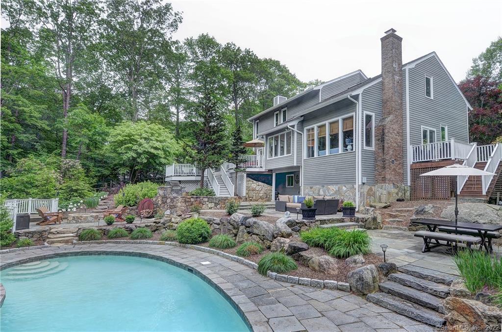 5 Middlebrook Pond Road Redding, CT 06896 - Photo 1 of 1 a front view of a house with sitting area and garden