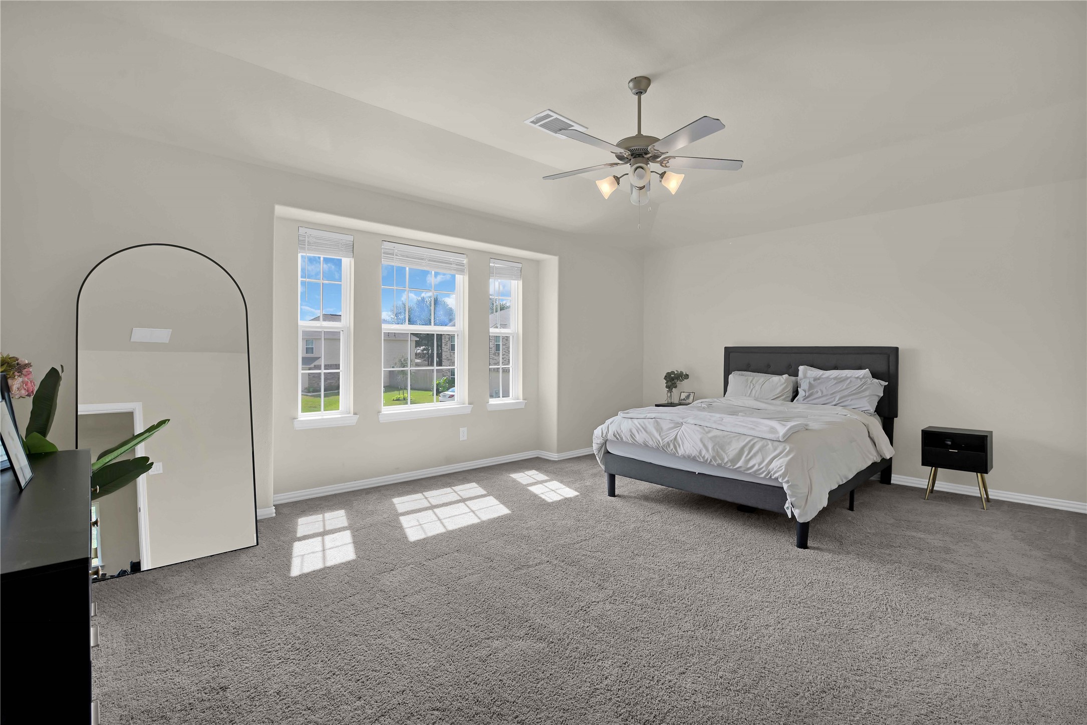 17703 Lion Heart Road Conroe, TX 77306 - Photo 14 of 26 a spacious bedroom with a bed and a window