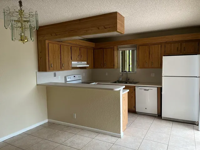 a kitchen with a refrigerator and a sink