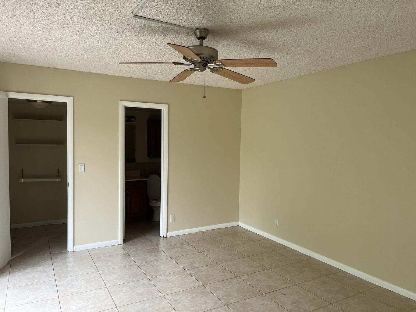 4602 Waterview Circle Palm Springs, FL 33461 - Photo 10 of 13 an empty room with a ceiling fan and a window