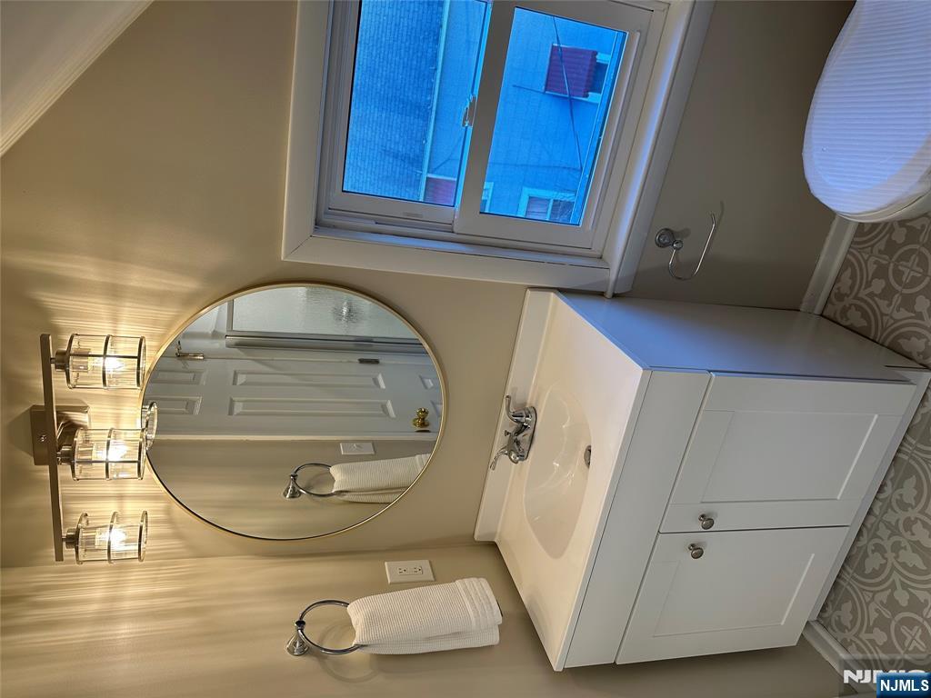 636-3 Ringwood Avenue, Unit 3 Wanaque, NJ 07465 - Photo 11 of 15 a bathroom with a sink mirror vanity and toilet