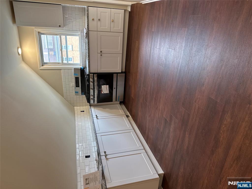 636-3 Ringwood Avenue, Unit 3 Wanaque, NJ 07465 - Photo 5 of 15 a kitchen with granite countertop white cabinets and white appliances