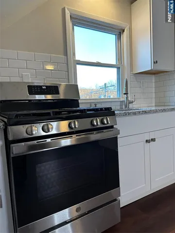 a stove top oven sitting inside of a kitchen
