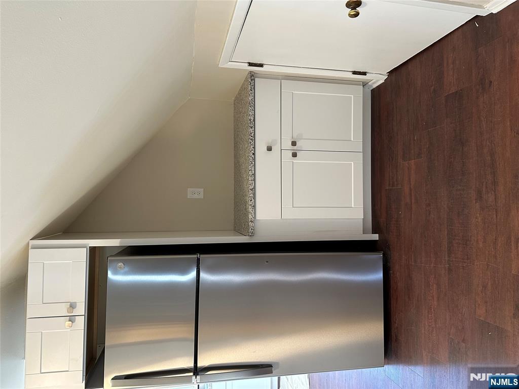 636-3 Ringwood Avenue, Unit 3 Wanaque, NJ 07465 - Photo 8 of 15 a view of a refrigerator in kitchen and white cabinets