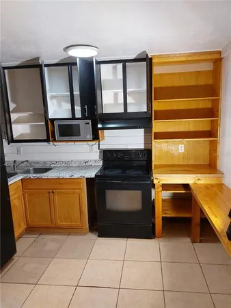 a kitchen with a cabinets and appliances