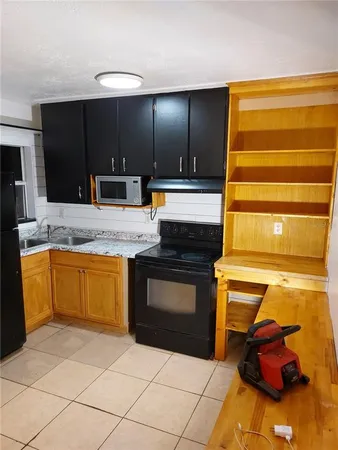 a kitchen with a sink cabinets and appliances
