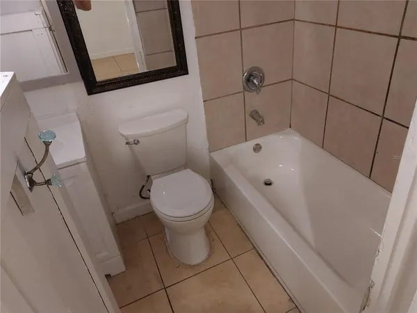 a bathroom with a toilet and a tub