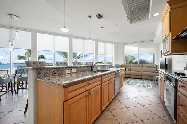 a view of kitchen with granite countertop cabinets table and chairs
