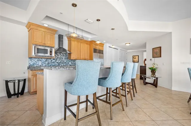 a large kitchen with stainless steel appliances granite countertop a sink and stove