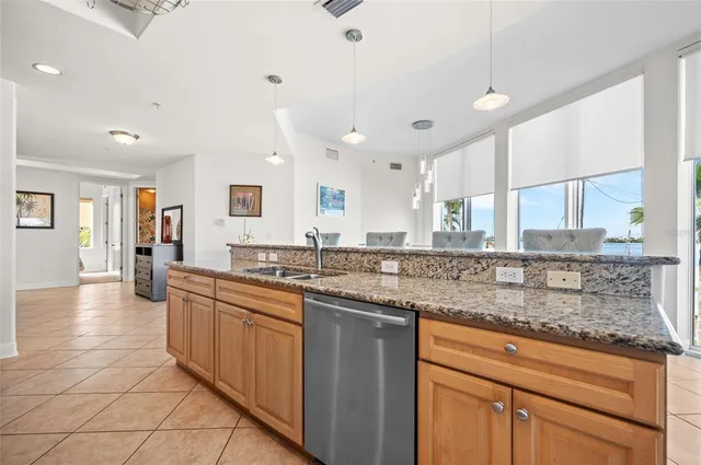 a kitchen with granite countertop a sink and a counter top space