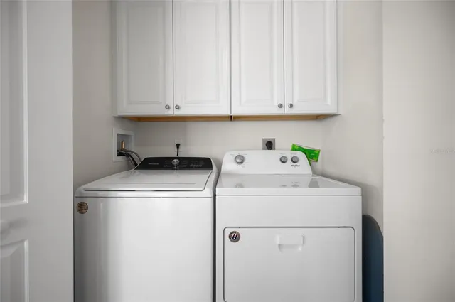 a bedroom with a bed and a refrigerator