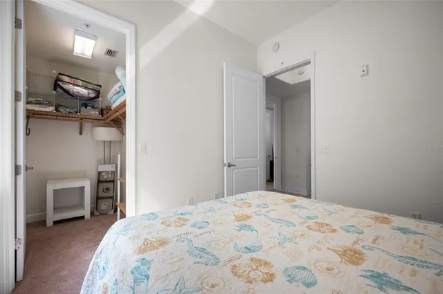 a bathroom with a granite countertop sink and a toilet