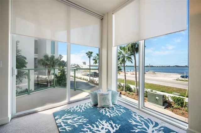a kitchen with granite countertop white cabinets stainless steel appliances and a counter space
