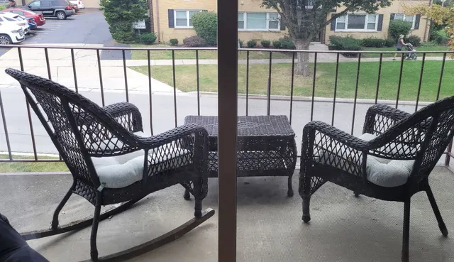 a view of a balcony with table and chairs
