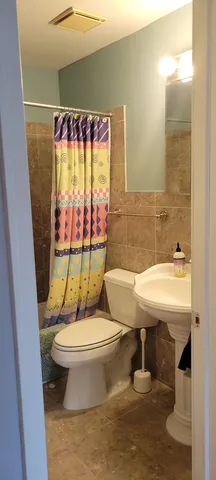 a bathroom with a sink toilet mirror and tub