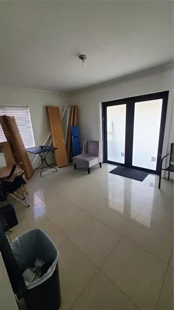 a living room with furniture a window and a sink