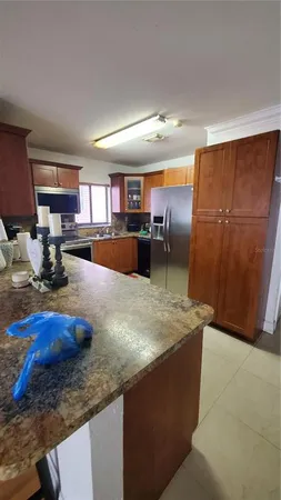 a kitchen with sink refrigerator and cabinets