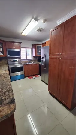 a kitchen with a refrigerator and window